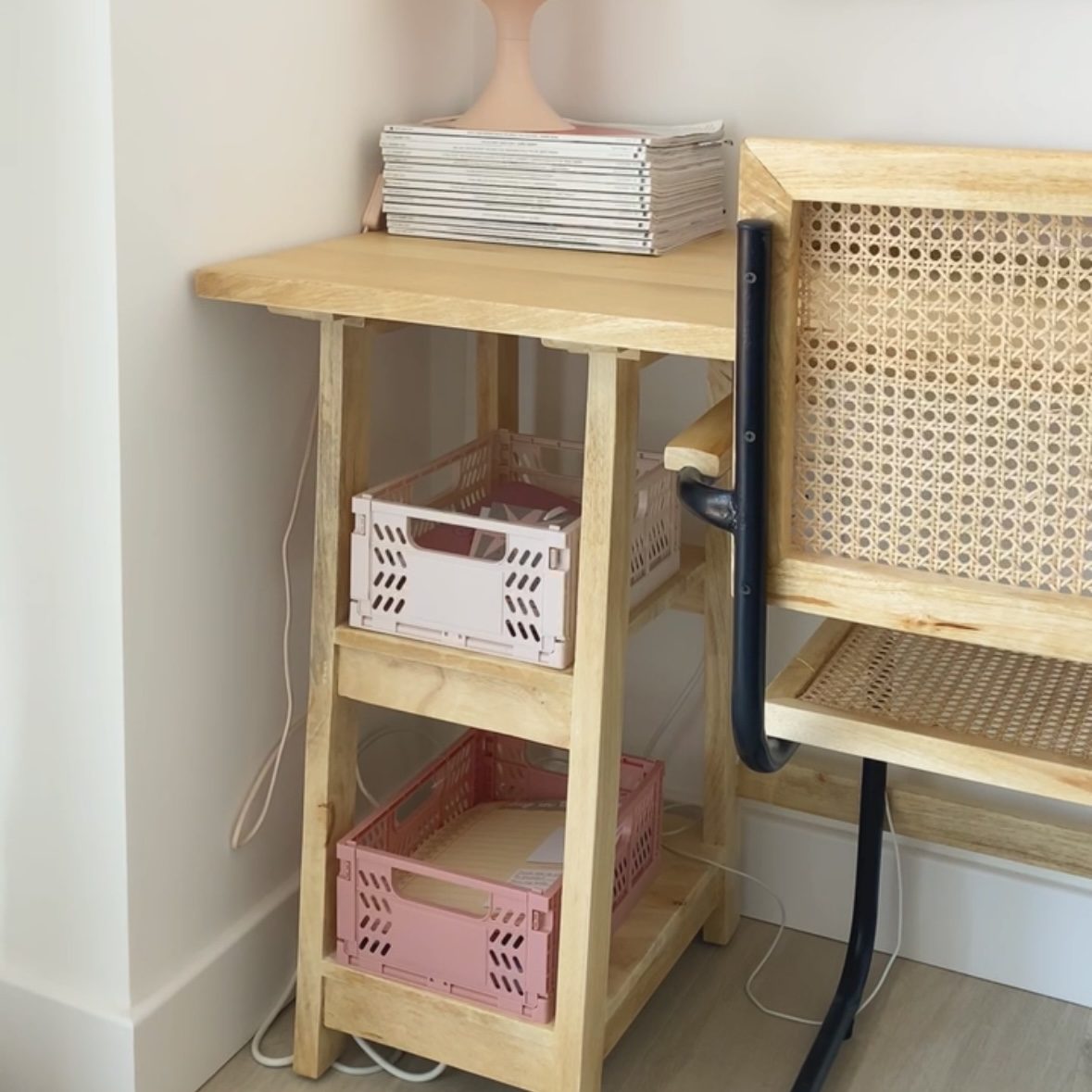 Pastel pink crates used for desk storage.