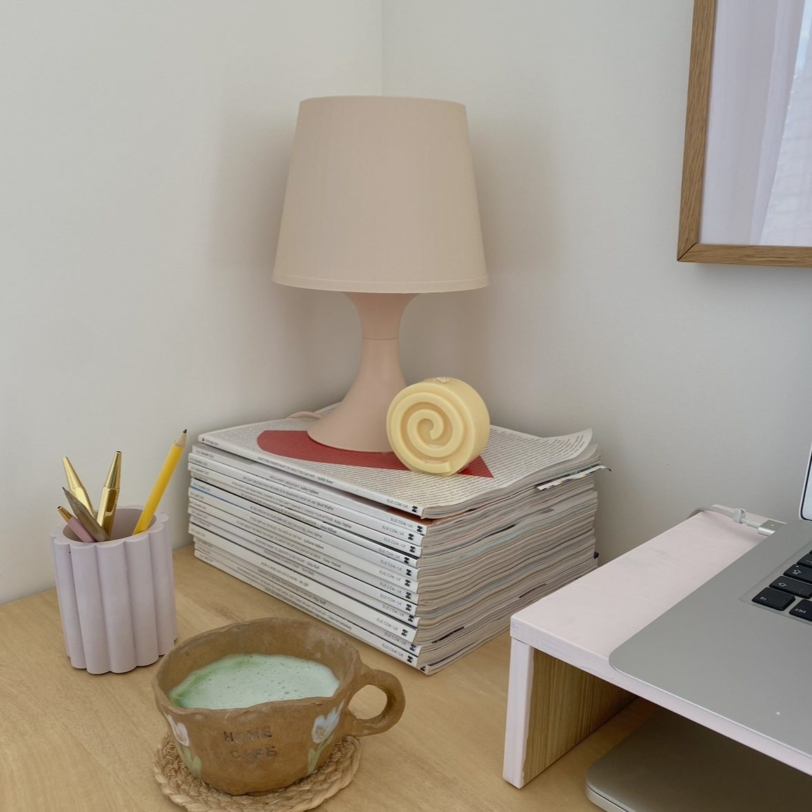 Stack of magazines on a desk.