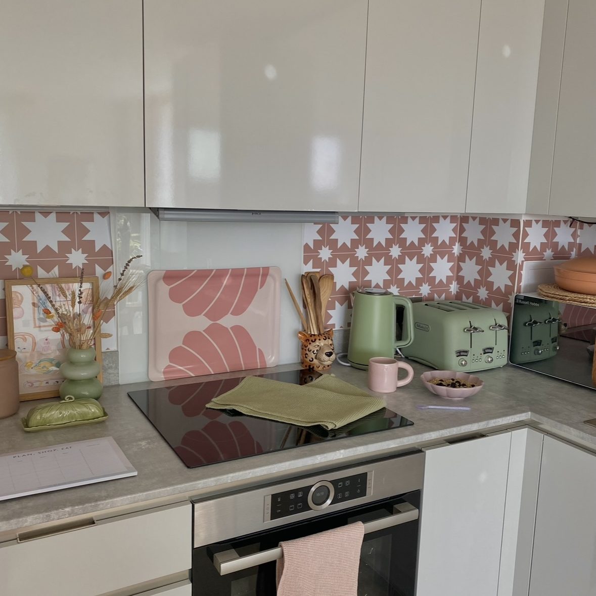Rented kitchen that has used pink star peel-and-stick tiles.